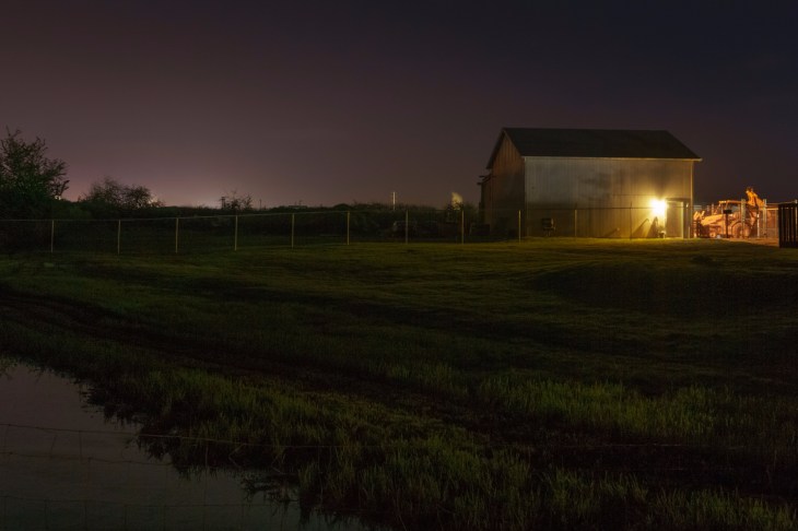 Outbuilding and tractor beside slough on Carol Avenue
